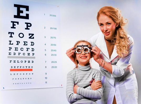 Pediatric Ophthalmologist examining a kid blinking